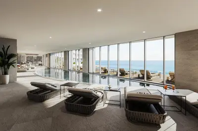 a living room with a pool and chairs and a table at Del Mar 2 Luxe Bedroom 'C' Highrise Residence in Limassol