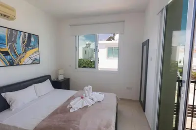 a bedroom with a bed and a window at Protaras Orestiada Villa OV14 in Protaras