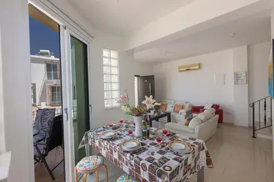 a living room with a table and a couch at Protaras Orestiada Villa OV14 in Protaras