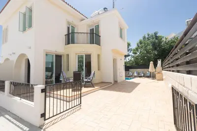 a large white house with a balcony and a patio at Protaras Orestiada Villa OV14 in Protaras