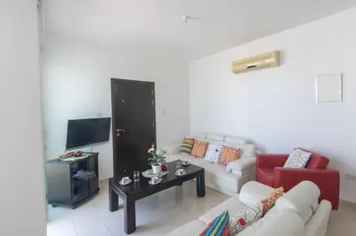 a living room with a couch and a table at Protaras Orestiada Villa OV14 in Protaras