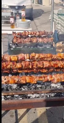 a bunch of food on a grill on a street at Petalmo City Apartments in Larnaka