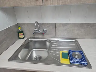 a sink in a kitchen with a faucet at Petalmo City Apartments in Larnaka