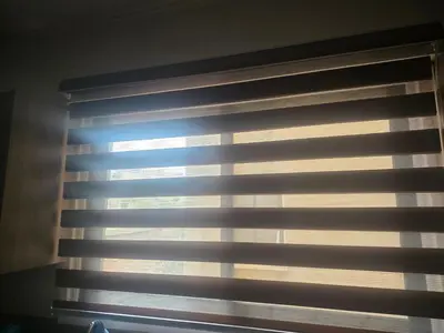 a window with blinds in a room at Petalmo City Apartments in Larnaka
