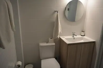 a bathroom with a toilet and a sink and a mirror at Les Palmiers Sunorama Beach Apartments in Larnaka