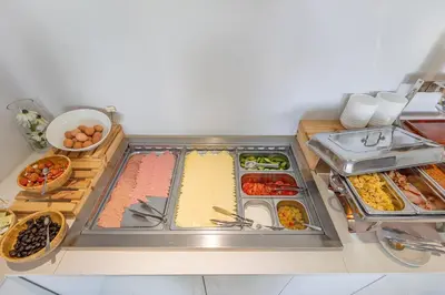 a kitchen counter with many different types of food at Bellini Hotel in Ayia Napa