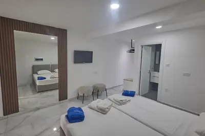a bedroom with a large bed and a mirror at Gold Emerging Villas Ltd Apart 5 in Ayia Napa
