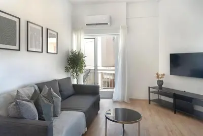 a living room with a couch and a tv at Phaedrus Living City Breeze Residences Urbanity in Larnaka