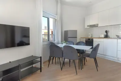 a kitchen and dining room with a table and chairs at Phaedrus Living City Breeze Residences Urbanity in Larnaka