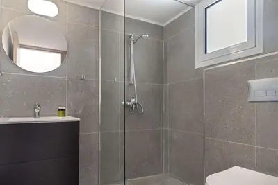 a bathroom with a shower and a toilet and a sink at Phaedrus Living City Breeze Residences Urbanity in Larnaka