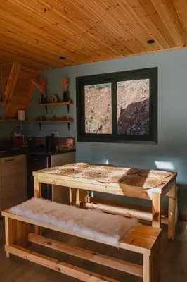 a wooden bed in a room with a window at Warm Family Glamping Cabin with Kids Playground in Arakapas