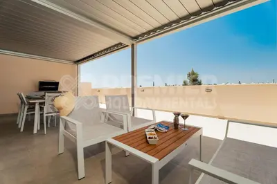 a room with a table and chairs on a balcony at Apartment Anabelle in Paralimni