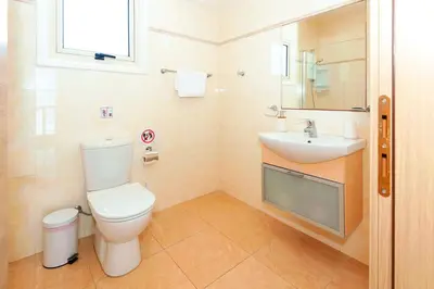a bathroom with a toilet and a sink at Villa Aurora - 100m from Pernera Beach in Protaras