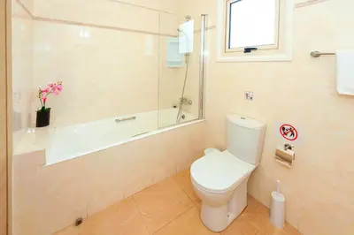 a bathroom with a toilet and a shower and a tub at Villa Aurora - 100m from Pernera Beach in Protaras