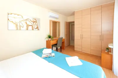 a bedroom with a bed and a desk in a room at Villa Aurora - 100m from Pernera Beach in Protaras