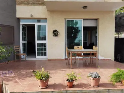 a patio with a table and chairs and plants at Lovely house apartment Oroklini in Voroklini