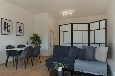 a living room with a blue couch and a table at Phaedrus Living City Breeze Residences Grace in Larnaka