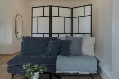 a blue couch with pillows in a living room at Phaedrus Living City Breeze Residences Grace in Larnaka