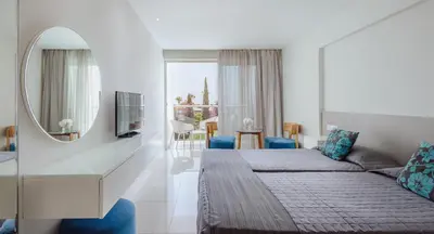 a hotel room with a bed and a mirror at River Rock Hotel in Ayia Napa