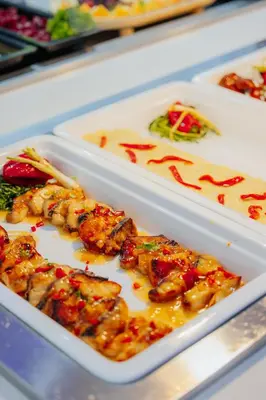 a tray of food with shrimp and other foods at River Rock Hotel in Ayia Napa