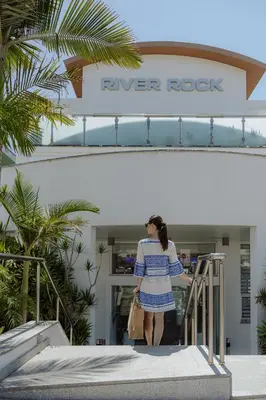 a woman standing in front of a river rock store at River Rock Hotel in Ayia Napa