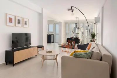 a living room with a couch and a tv at Amazing Two Bedroom Apartment in Larnaka