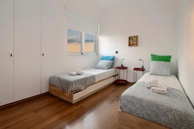 a bedroom with two beds and a window at Amazing Two Bedroom Apartment in Larnaka