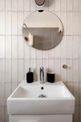 a bathroom with a white sink and a mirror at Amazing Two Bedroom Apartment in Larnaka