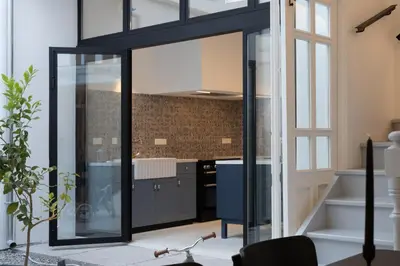 a kitchen with sliding glass doors in a house at 1924 Gemini House Jacuzzi, Garden, Rooftop in Nicosia