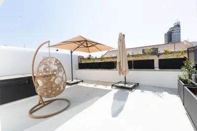 a chair and an umbrella on a roof at 1924 Gemini House Jacuzzi, Garden, Rooftop in Nicosia