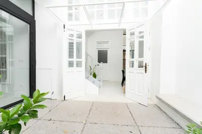 an open hallway with white doors and plants at 1924 Gemini House Jacuzzi, Garden, Rooftop in Nicosia