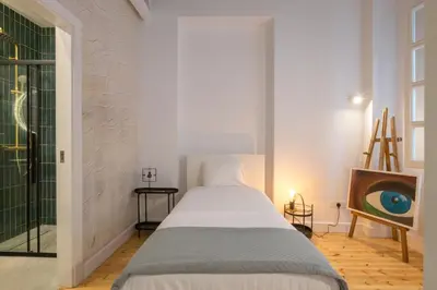 a white bedroom with a bed and a window at 1924 Gemini House Jacuzzi, Garden, Rooftop in Nicosia