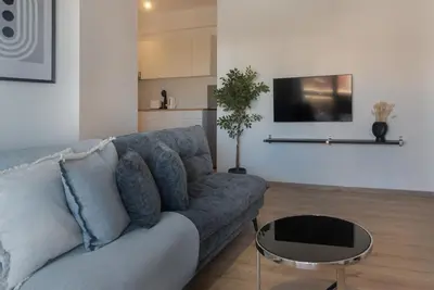 a living room with a couch and a table at Phaedrus Living City Breeze Residences Finesse in Larnaka