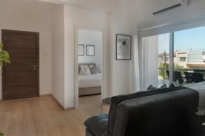 a living room with a couch and a bed and a mirror at Phaedrus Living City Breeze Residences Finesse in Larnaka