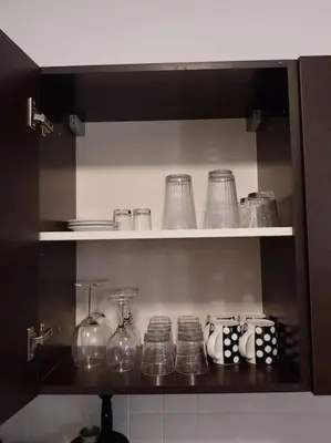 a shelf with glasses and other glass items on it at City Center Top Floor Big Balcony 2BR Close to the Beach in Larnaka