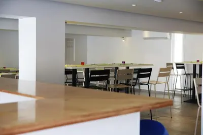 an empty room with a long table and chairs at Sea CleoNapa Hotel in Ayia Napa