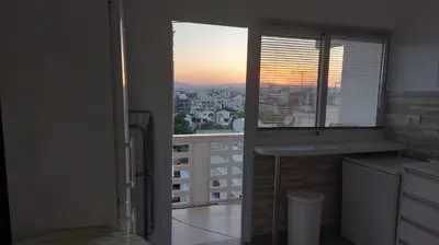 a kitchen with a window and a view of a city at ideal famille panoramic view lac salé in Larnaka