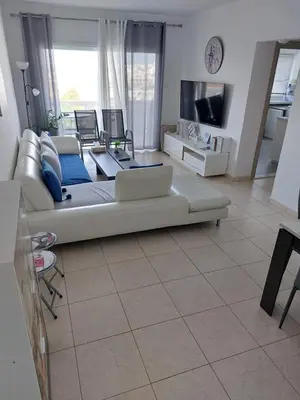 a living room with a couch and a tv at ideal famille panoramic view lac salé in Larnaka