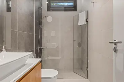a bathroom with a shower and a toilet and a sink at Serenity Waves Villa 19 in Larnaka