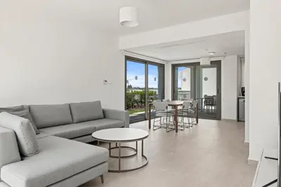 a living room with a couch and a table at Serenity Waves Villa 19 in Larnaka