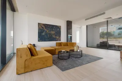 a living room with a couch and a table at Protaras Eden Seaside Suite in Protaras