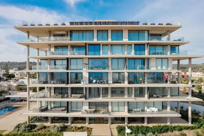 an apartment building with balconies and a pool at Protaras Eden Seaside Suite in Protaras