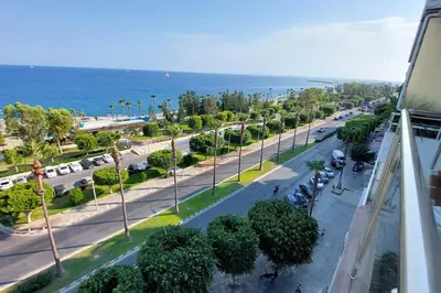 arial view of a street with trees and the ocean at Limassol Molos Hawaii Royal - Front-line 2 bedroom in Limassol