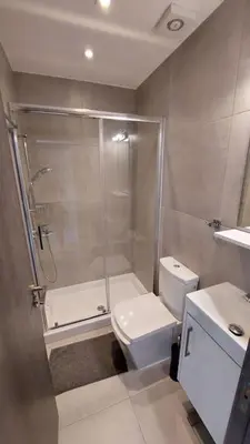 a bathroom with a shower and a toilet and a sink at Limassol Molos Hawaii Royal - Front-line 2 bedroom in Limassol