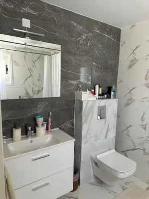 a bathroom with a sink and a toilet and a mirror at Beachfront villa Meneou in Meneou