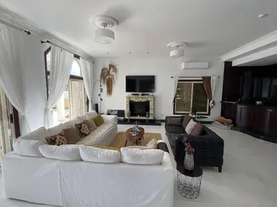 a living room with a white couch and a table at Beachfront villa Meneou in Meneou
