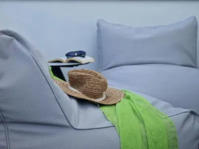 a hat sitting on the back of a couch at Sea Front Luxury Apartment in Voroklini