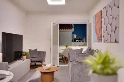 a living room with a couch and chairs and a table at Sea Front Luxury Apartment in Voroklini