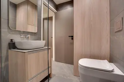 a bathroom with a white toilet and a sink at Sea Front Luxury Apartment in Voroklini