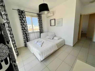 a bedroom with a white bed and a window at Thaleia Suite - Tourism License 3119 in Protaras